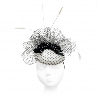 Polka-dot straw pillbox hat with a silk ruffle and feathers