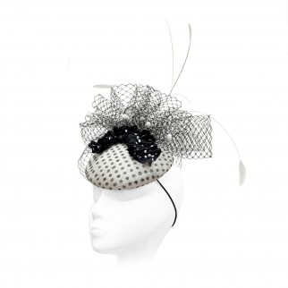 Polka-dot straw pillbox hat with a silk ruffle and feathers