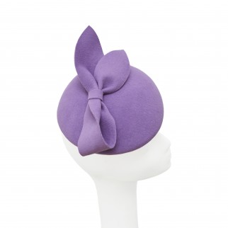 Asymmetrical pill-box hat with a bow